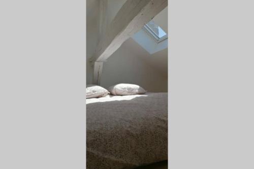 une chambre avec un lit dans un grenier dans l'établissement Cosy Studio hyper centre 1, à Orléans