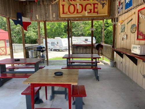 a group of picnic tables sitting inside of a building at Reel Inn and Lodge in Quitman