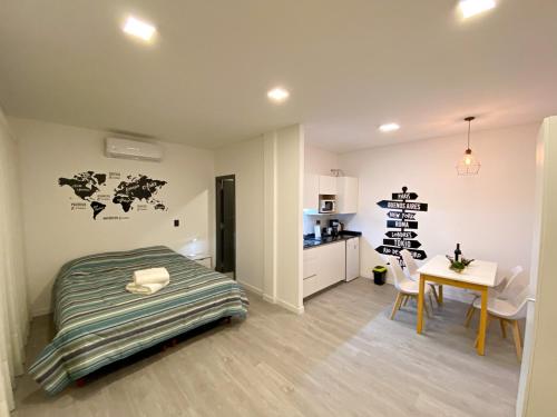 a bedroom with a bed and a kitchen with a table at Luxury Apartments in Mendoza