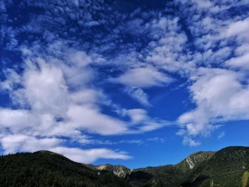 a blue sky with white clouds over mountains at ManBuYunDuan.Theme Inn in Wutai