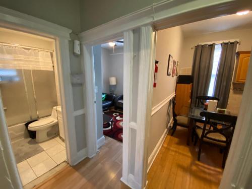 a hallway with a bathroom with a toilet and a desk at Cozy apt in WEST NY, NEW JERSEY, at 2 bloks from bus stop-15 minutes 2NY 7MINUTES VIA NYWATERWAY FERRY-BETTER CAN'T BE!! in West New York