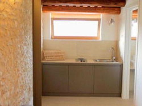 a kitchen with a sink and a window at Homely Farmhouse in Pagnano Italy near Forest in Asolo