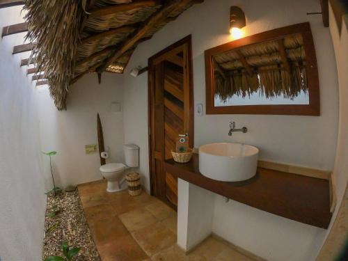 a bathroom with a sink and a toilet at Na Praia Pousada in Barra Grande