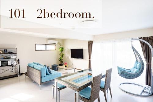 a living room with a table and chairs at HOTEL FIT IN ISHIGAKIJIMA 新築2021年4月OPEN セキュリティ万全 セルフチェックイン -SEVEN Hotels and Resorts- in Ishigaki Island