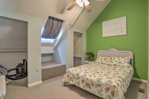 a bedroom with green walls and a bed and stairs at Resort-Style Condo with Lake-View Balcony! in Put-in-Bay