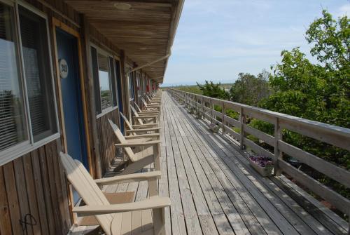 a row of chairs sitting on the porch of a building at Ocean Vista Resort in Amagansett