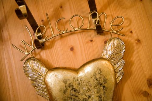 a heart shaped metal ornament on a wall with scissors at Hotel Magdalena Mayrhofen in Mayrhofen