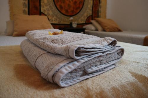 a pile of towels sitting on top of a bed at Villa Sunshine Countryside Resort in Frigiliana