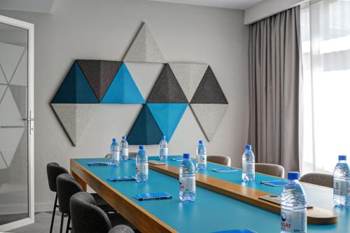a meeting room with a long table with water bottles at Holiday Inn Express - Almaty by IHG in Almaty