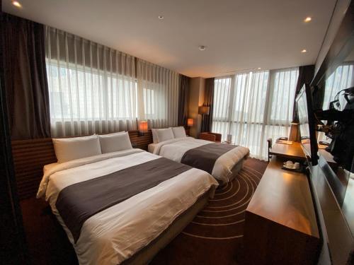 Postel nebo postele na pokoji v ubytování Best Louis Hamilton Hotel Haeundae