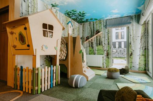 a childrens room with a play area with a play house at VISLOW Resort in Wisła