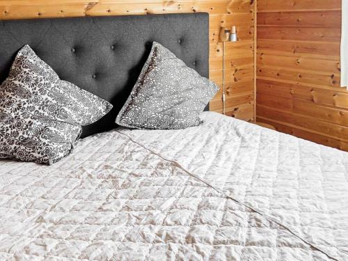a bed with two pillows on top of it at 8 person holiday home in Norheimsund-By Traum in Norheimsund