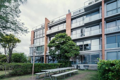 an office building with benches in front of it at Sandbox beachfront villa2 in Bang Lamung