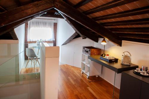 a kitchen with a desk and a chair in a room at Ca' della Scimmia - Rialto Bridge, Venice in Venice