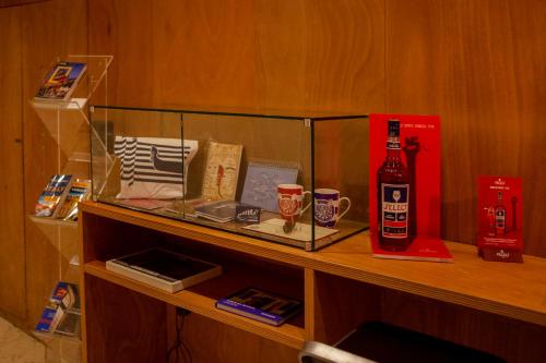 a shelf with a bottle of beer and a bottle of wine at Ca' della Scimmia - Rialto Bridge, Venice in Venice