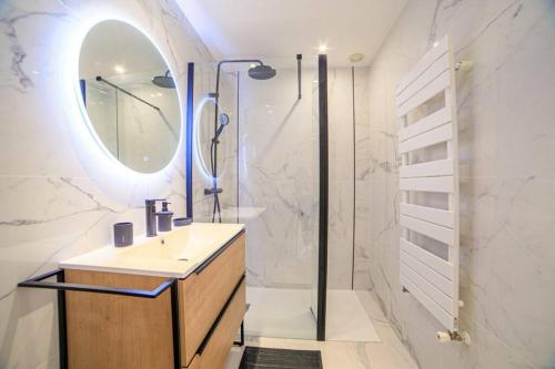une salle de bain avec un lavabo et une douche avec un miroir dans l'établissement Le Bain De Soleil - Le Bain De Soleil 5 star Two bedroom apartment, à Cannes