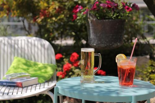 a table with a drink and a glass on it at Hotel Villa Clara in Nago-Torbole