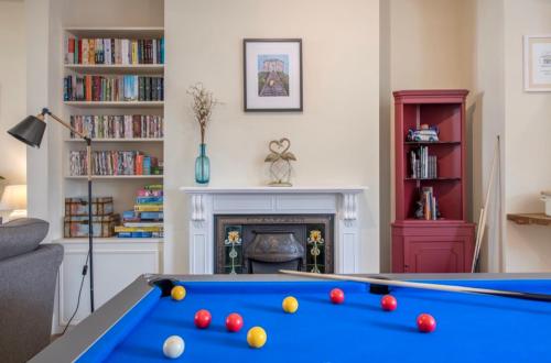 a living room with a pool table and a fireplace at 109 Nunnery Lane - a House of York holiday home in York