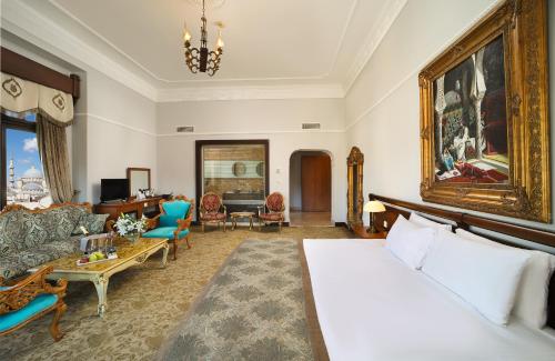 a bedroom with a bed and a living room at Legacy Ottoman Hotel Istanbul Old City in Istanbul