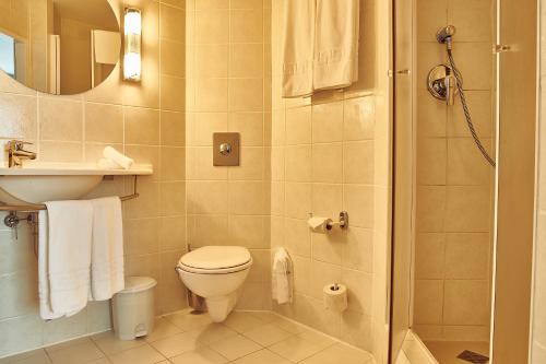 a bathroom with a toilet and a sink at Continental Forum Bucuresti Palatul Parlamentului in Bucharest