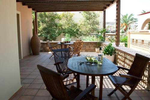 a patio with a table and chairs on a patio at Mylos Hotel Apartments in Plataniás