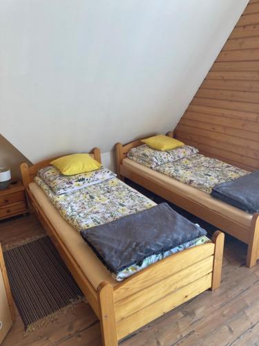 two twin beds in a room with at Agroturystyka Skałka in Wisła