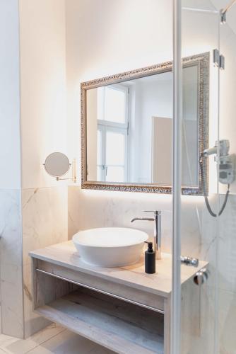 a bathroom with a sink and a mirror at CMA Stift Ossiach in Ossiach