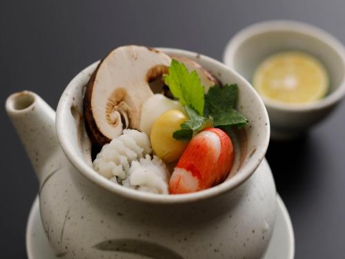 a white bowl filled with sushi and vegetables at Wakasa Annex in Nara