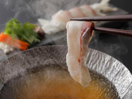 a piece of meat is being cooked in a bowl at Wakasa Annex in Nara