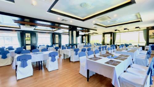 a banquet hall with white tables and chairs at Sea Pearl Cat Ba Hotel in Cat Ba