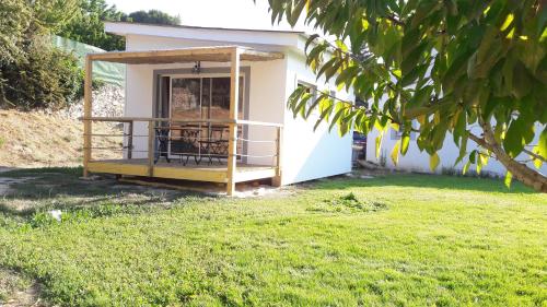 a tiny house with a porch in a yard at Le chalet de La Treille in Marseille