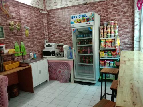 a kitchen with a refrigerator with food in it at Natcha Place TU Rangsit in Ban Bang Khan