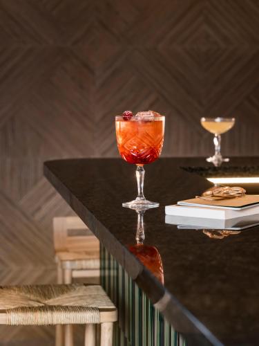 a drink in a glass on a table at OKKO Hotels Nice Aéroport in Nice