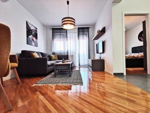 a living room with a couch and a table at Apartman Angel in Osijek