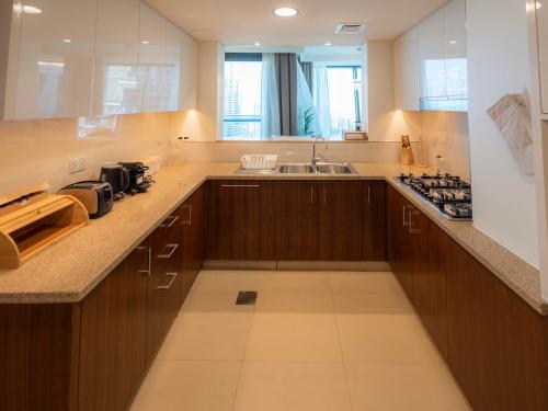 A kitchen or kitchenette at FIRST CLASS 3BR with full BURJ KHALIFA and FOUNTAIN VIEW