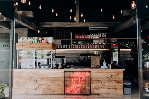 a restaurant counter with a red neon sign on it at Hotel 4x4 in Rivne