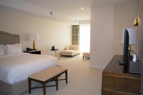 a hotel room with a bed and a television at YO1 Longevity & Health Resorts, Catskills in Monticello