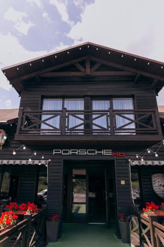 a building with a sign on the front of it at Hotel 4x4 in Rivne
