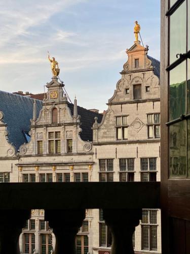 a large building with a statue on top of it at Antwerp City Hostel in Antwerp