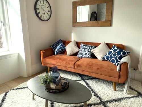 a living room with a couch and a table at The Portside Apartment in Greenock