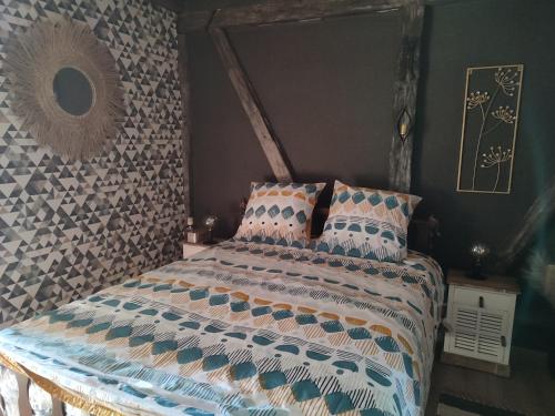a bedroom with a bed with pillows on it at Les Arpents Verts in Momignies