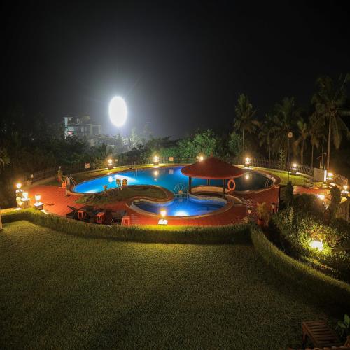 a large swimming pool at night with lights at Gateway Varkala in Varkala