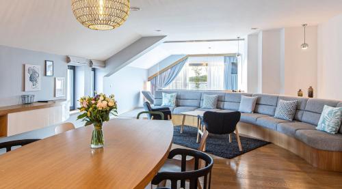 a living room with a couch and a table at Hotel Marina Club in Olsztyn