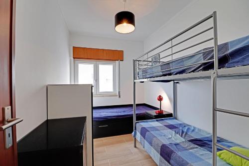 a bedroom with two bunk beds and a window at Portimao Marina View by Homing in Portimão