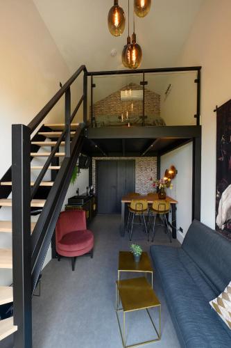 a living room with a loft bed and a table at Onder de Molen in Garderen