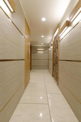 a corridor of a hospital with wooden walls and a walkway at Hotel Elysian Residency in Ahmedabad