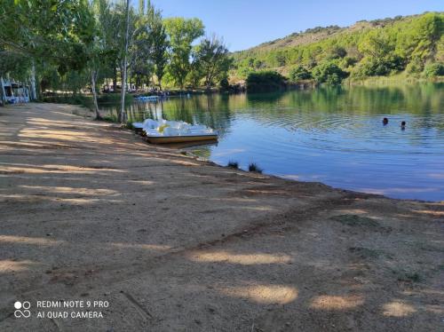 a boat in the water next to a lake at Jesús Del Perdón in Manzanares