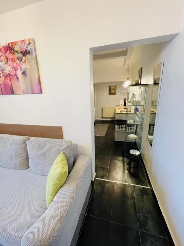 a small bedroom with a bed and a bathroom at Perfect Place to Stay self check in-24h-NETFLIX-WIFI in Reşiţa