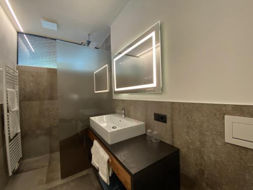 a bathroom with a sink and a mirror at Berghotel Plagött in San Valentino alla Muta