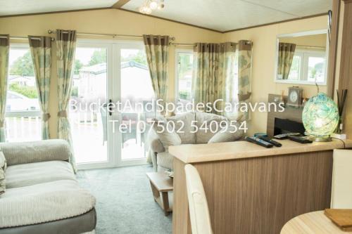 a living room with a couch and a table at Blackpool caravans Marton mere in Blackpool